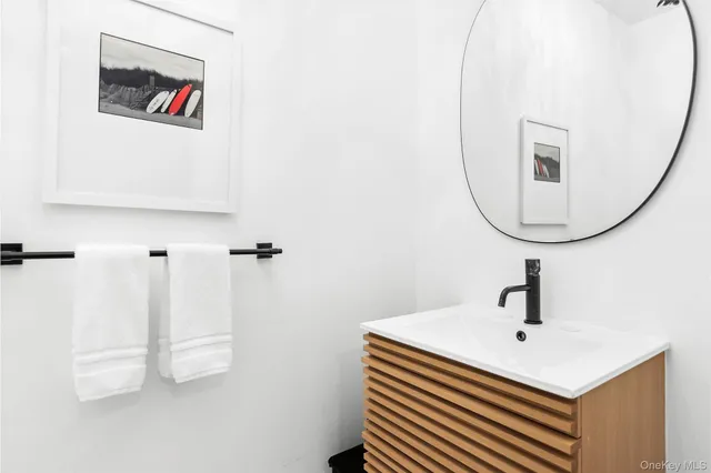 a bathroom with a sink a mirror and vanity