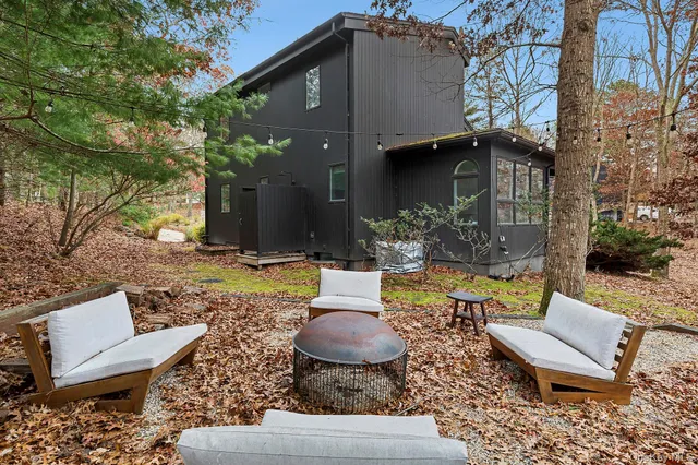a view of a patio with couches table and chairs and potted plants