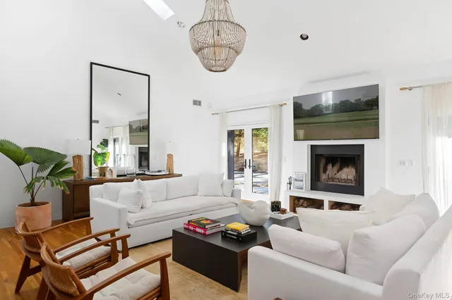 a living room with furniture a flat screen tv and a fireplace