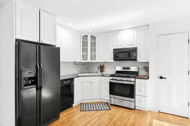 a kitchen with stainless steel appliances a refrigerator stove and microwave