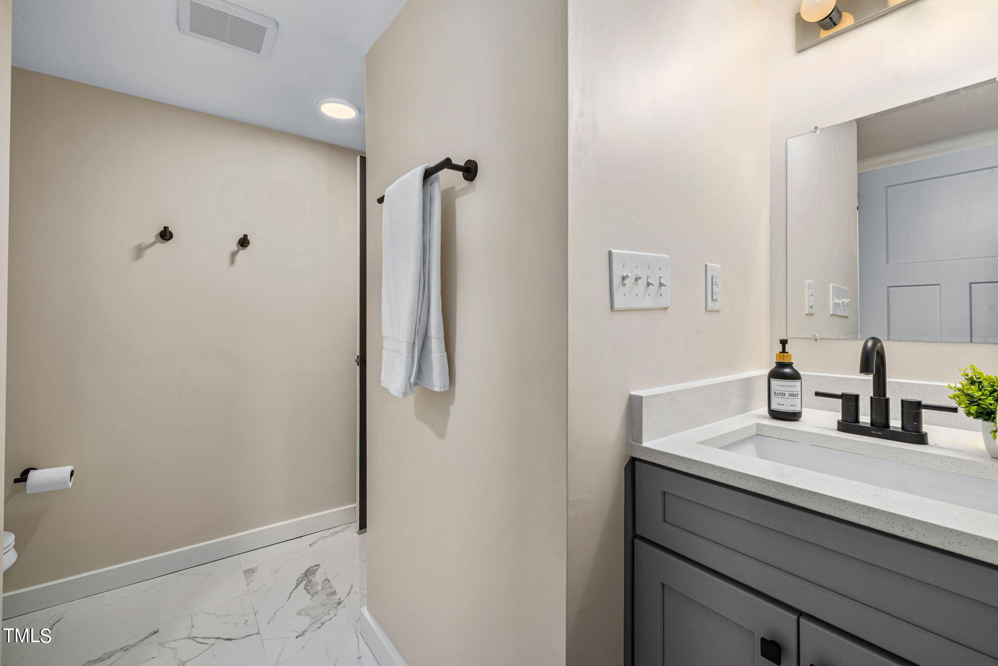 5020 Flint Ridge Place Raleigh, NC 27609 - Photo 17 of 30 a bathroom with a sink and a mirror