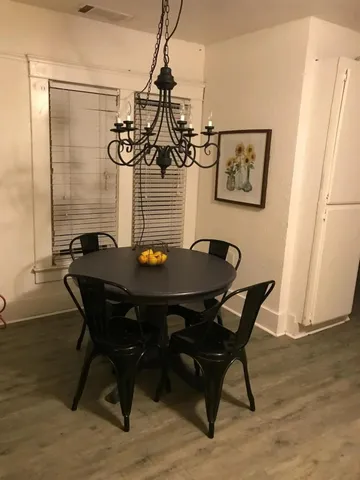 a view of a dining room with furniture and wooden floor