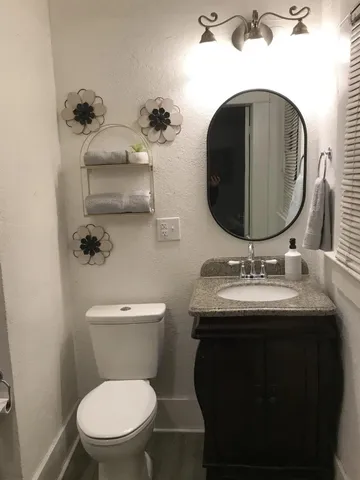 a bathroom with a toilet sink and mirror