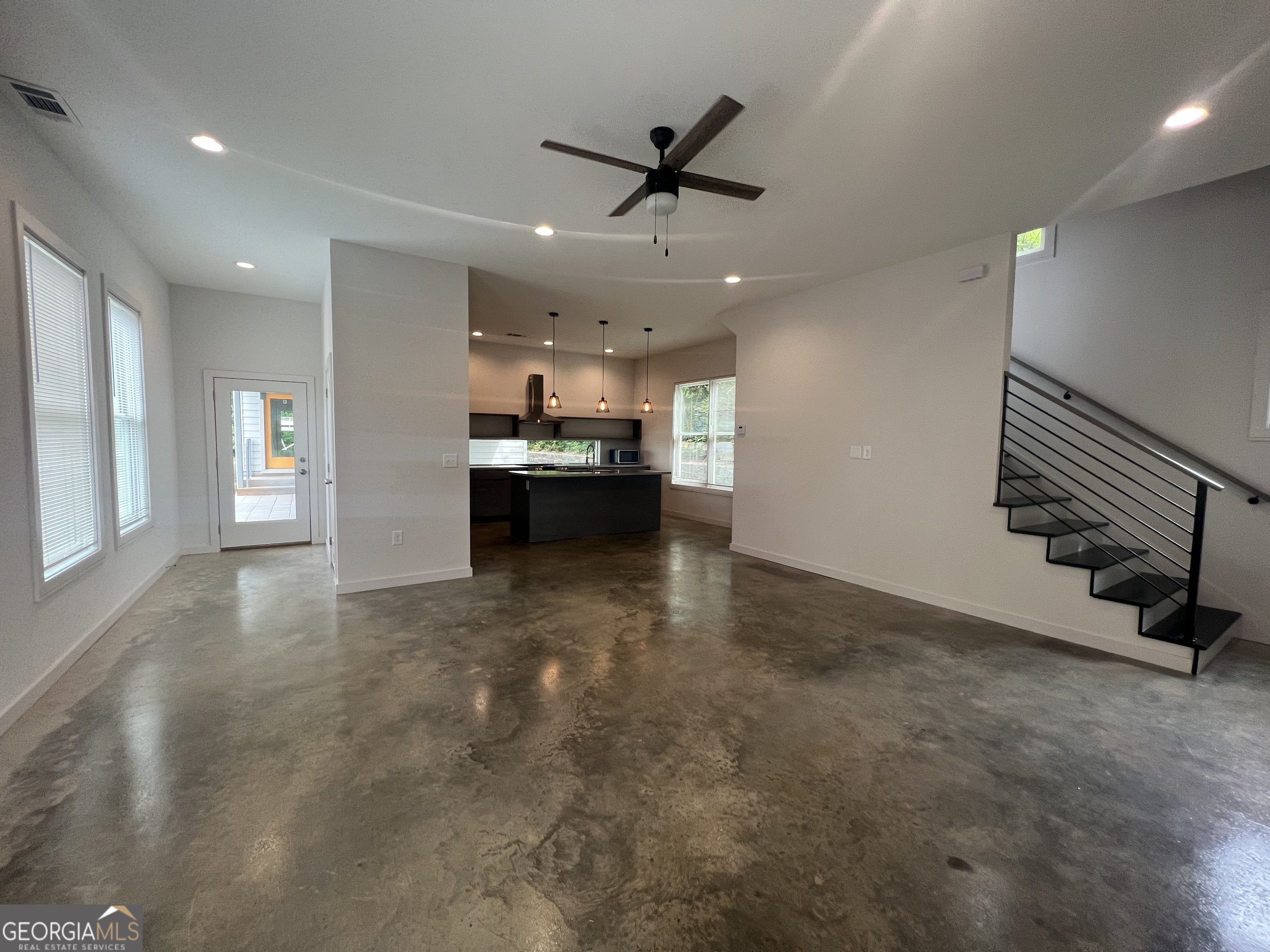 221 North Avenue Athens, GA 30601 - Photo 2 of 7 a view of a livingroom with a ceiling fan and kitchen space