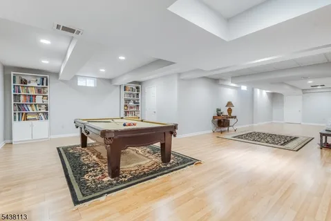 a living room with furniture a table and wooden floor