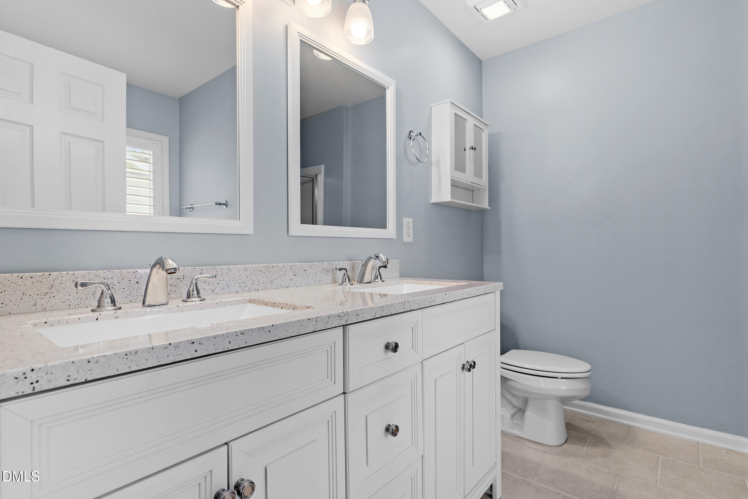 3147 Rapid Falls Road Cary, NC 27519 - Photo 27 of 34 a bathroom with a granite countertop sink a toilet and a mirror