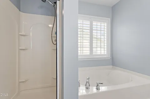 a white bath tub sitting next to a window