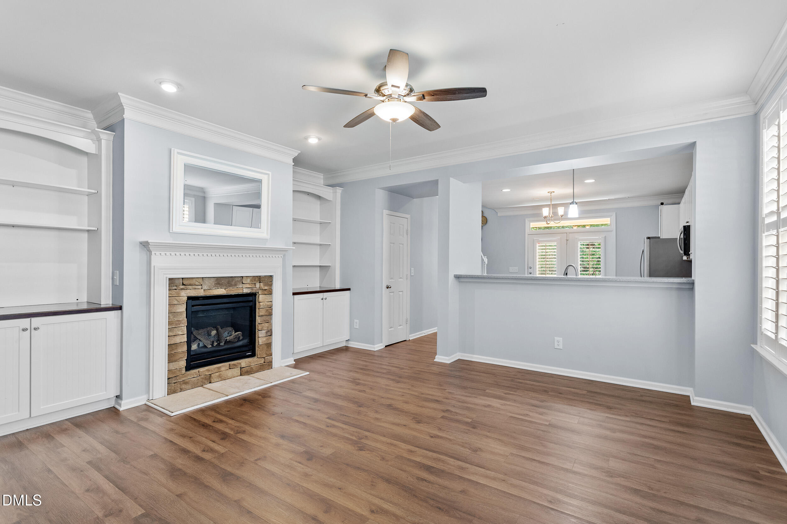 3147 Rapid Falls Road Cary, NC 27519 - Photo 3 of 34 a view of an empty room with wooden floor fireplace and a window