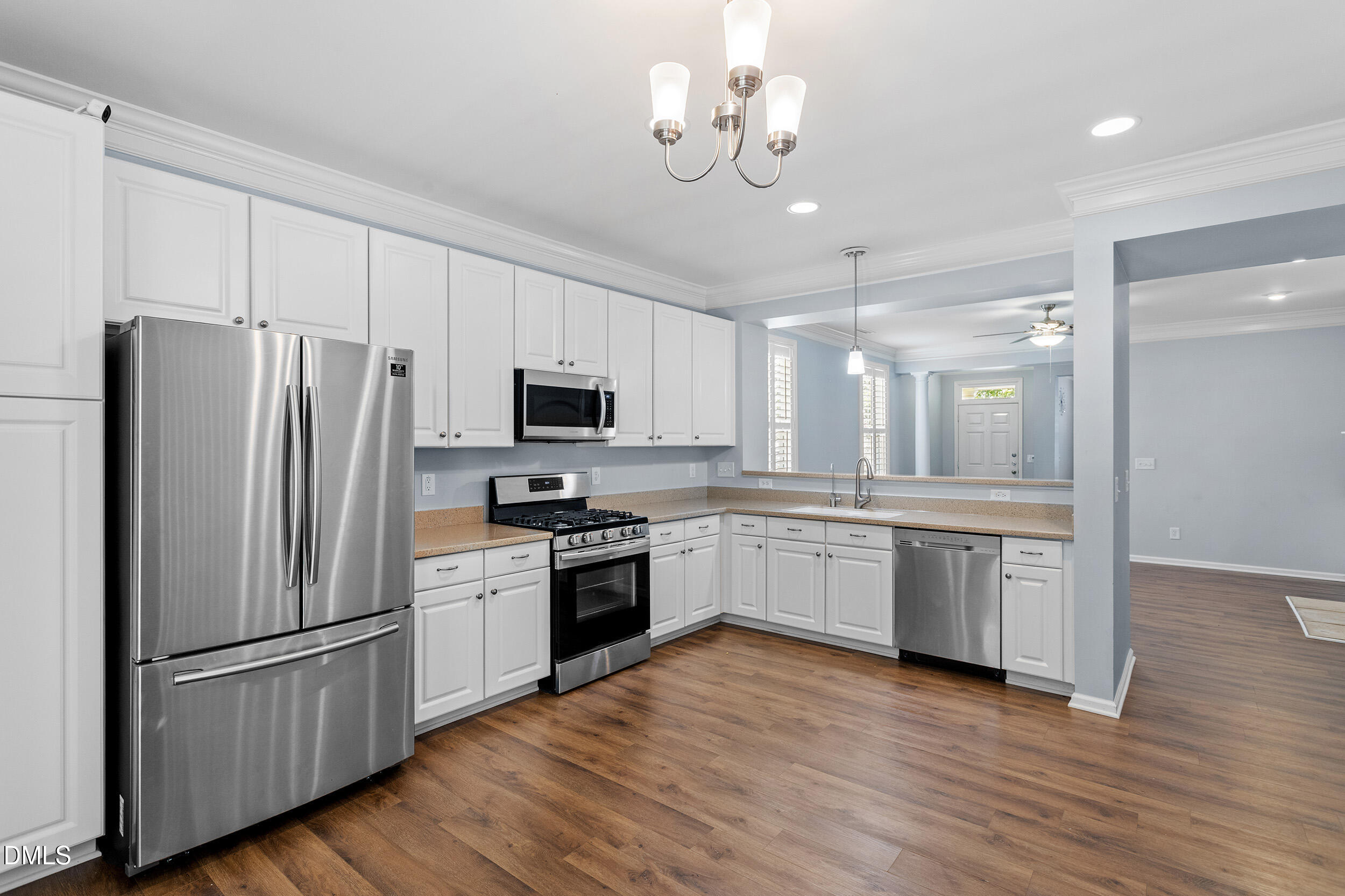 3147 Rapid Falls Road Cary, NC 27519 - Photo 4 of 34 a kitchen with granite countertop stainless steel appliances a refrigerator a sink cabinets and wooden floor