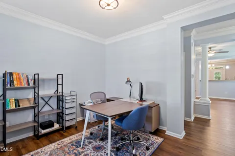 a view of a workspace with furniture and wooden floor