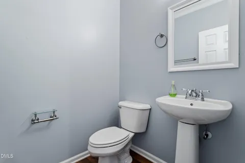 a bathroom with a sink toilet and mirror