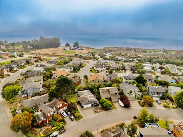 an aerial view of residential houses with outdoor space