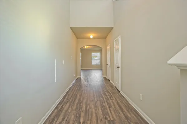 a view of a hallway with wooden floor