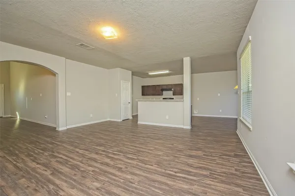 a view of a room with wooden floor