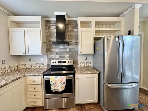 a kitchen with stainless steel appliances granite countertop a sink and cabinets