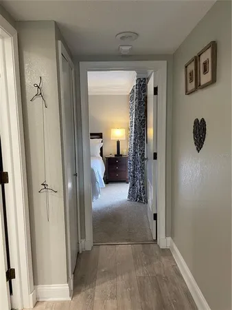 a view of a hallway view with three rooms