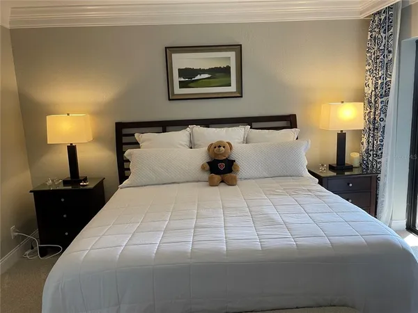a bedroom with a bed and lamp