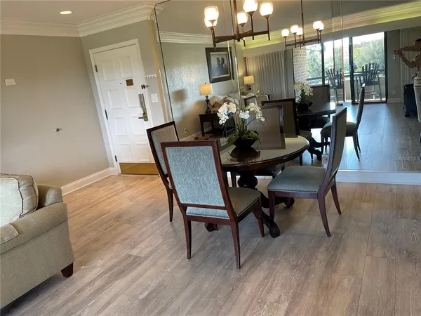 a dining room with furniture and wooden floor