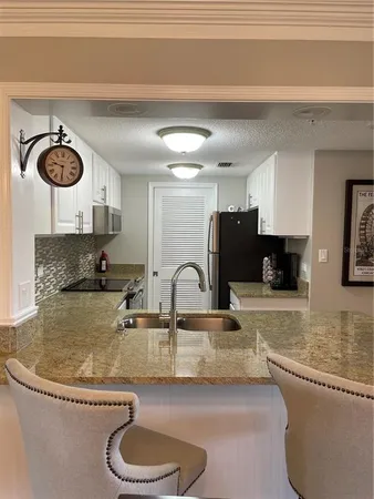 a kitchen with a stove a sink and a refrigerator