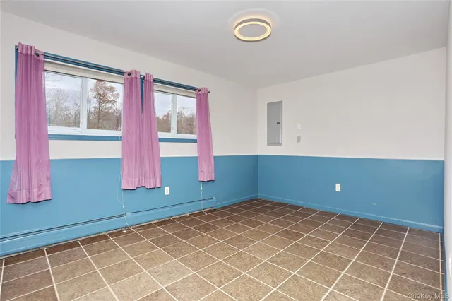 a view of a house with a barbeque and wooden stairs