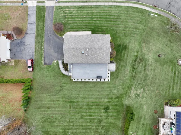 a aerial view of a house with a yard table and chairs
