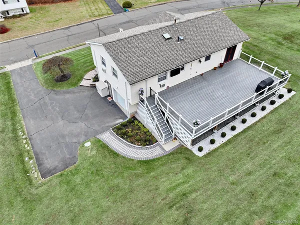 an aerial view of a house with backyard
