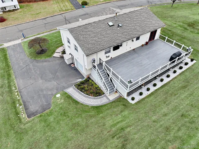 an aerial view of a house with backyard