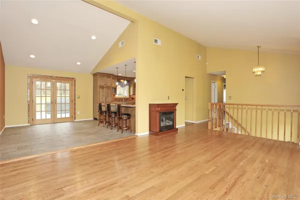 a view of a livingroom with furniture wooden floor and window