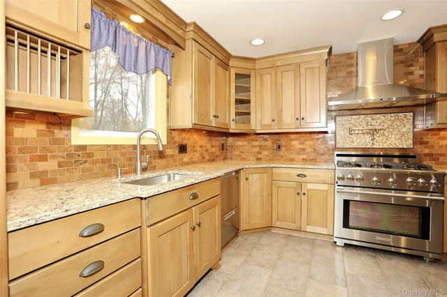 a kitchen with stainless steel appliances a refrigerator sink and cabinets