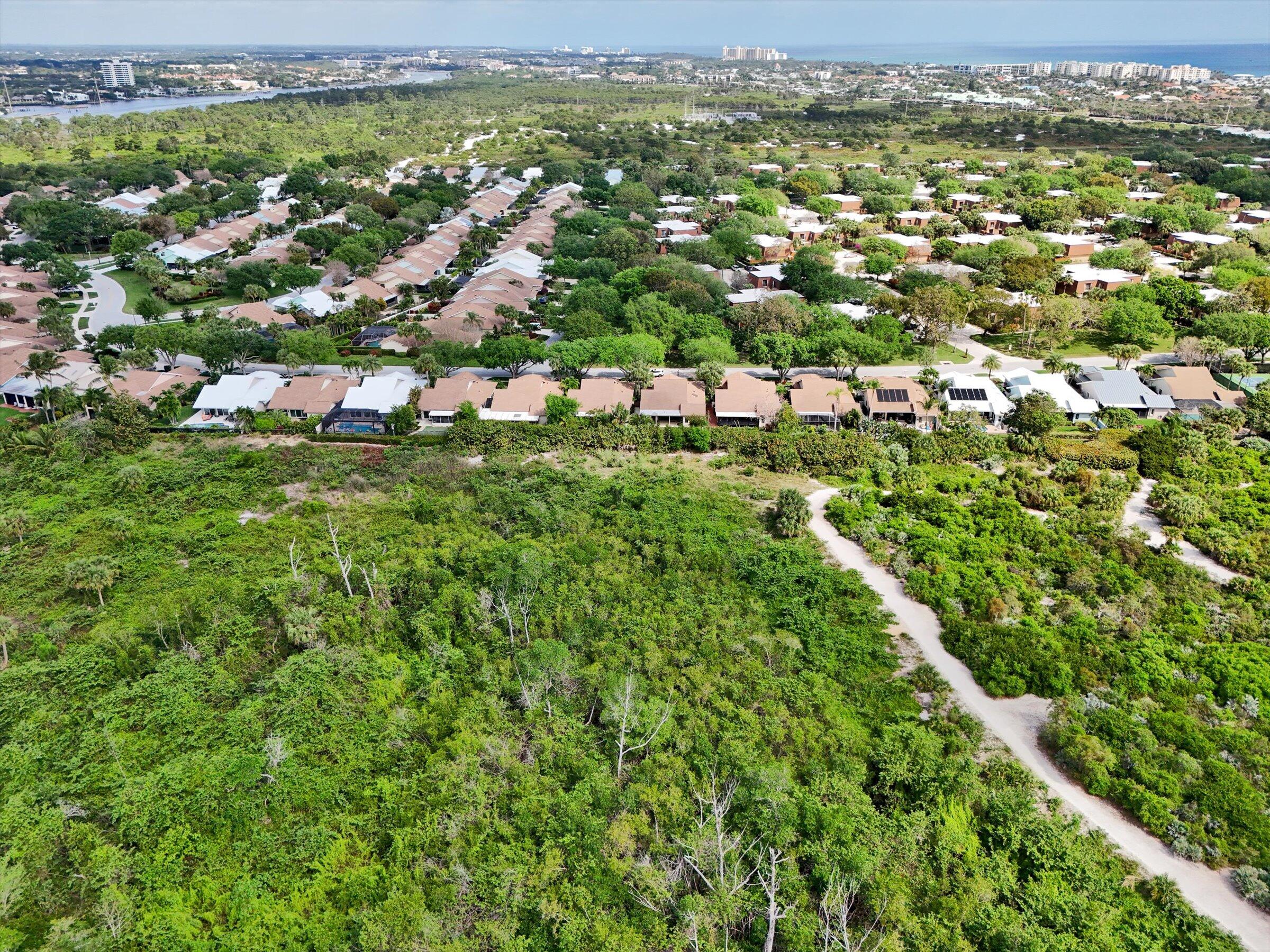 316 River Edge Road Jupiter, FL 33477 - Photo 17 of 53 an aerial view of residential houses with outdoor space and trees