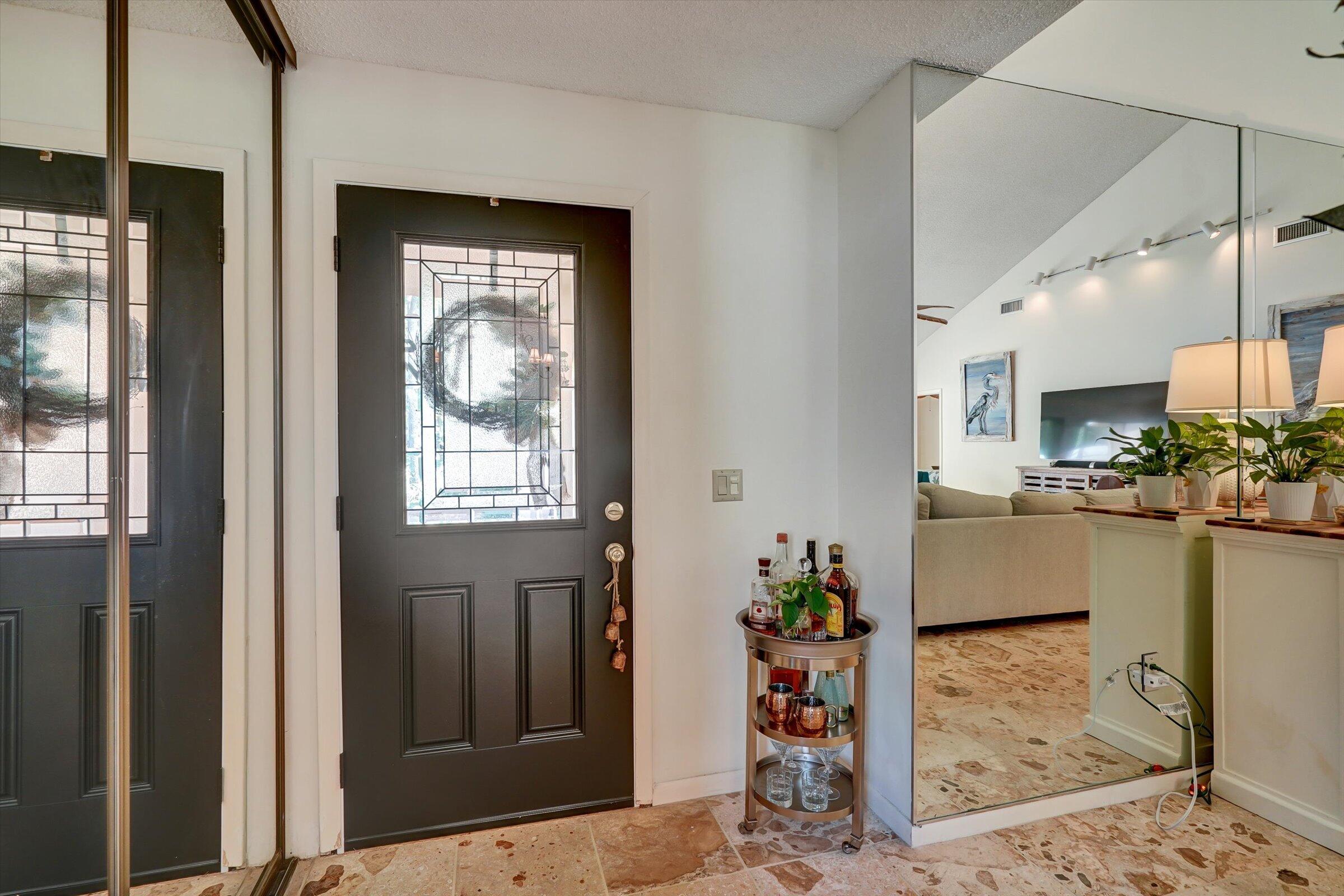 316 River Edge Road Jupiter, FL 33477 - Photo 22 of 53 a room with painting on the wall and windows