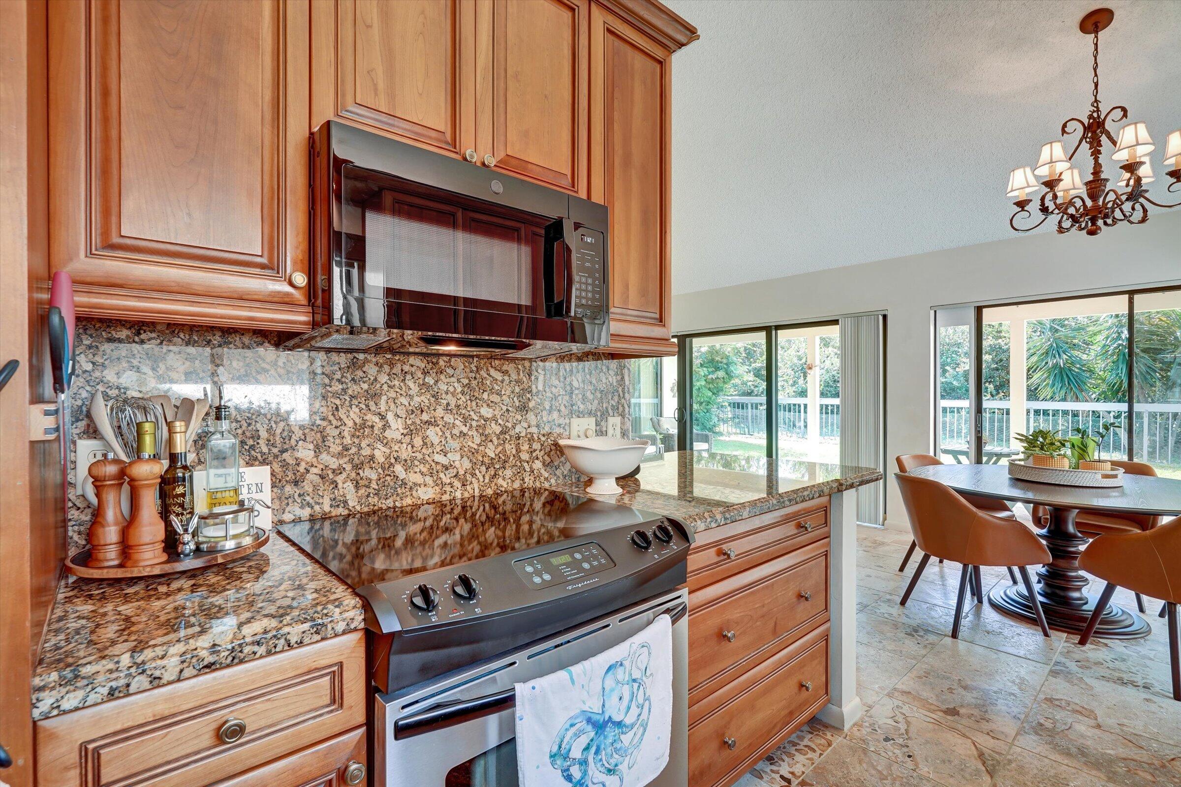 316 River Edge Road Jupiter, FL 33477 - Photo 25 of 53 a kitchen with a stove and a microwave