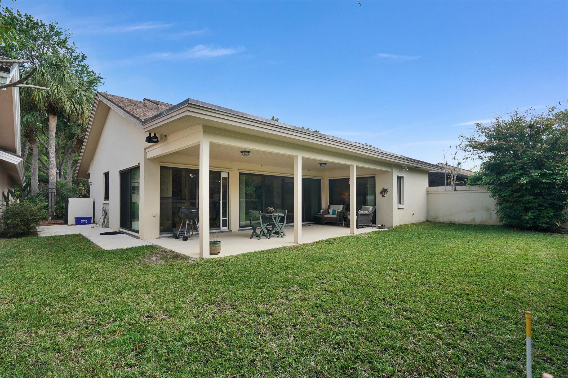 316 River Edge Road Jupiter, FL 33477 - Photo 31 of 53 a view of a house with backyard porch and garden