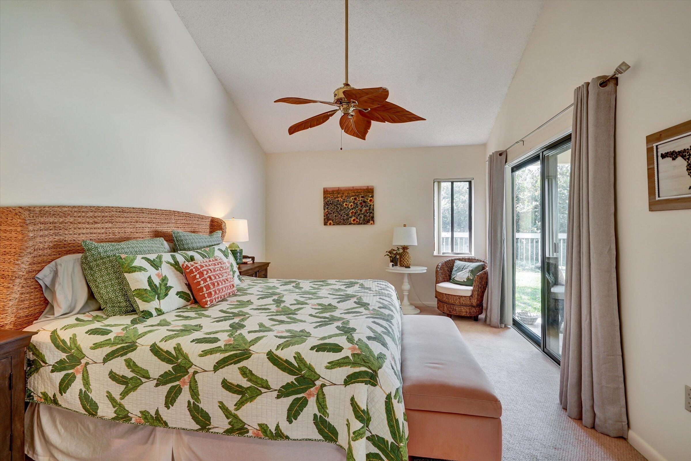 316 River Edge Road Jupiter, FL 33477 - Photo 35 of 53 a bedroom with a large bed and a chandelier