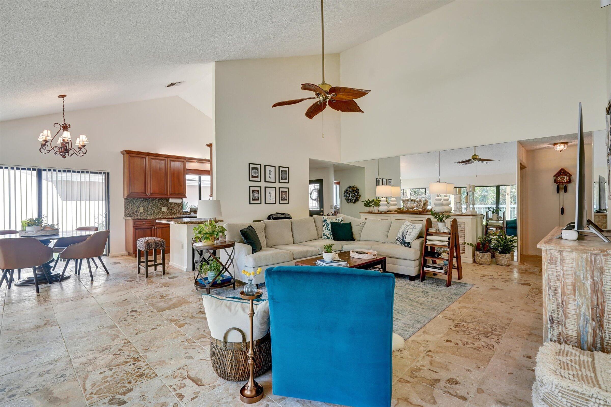 316 River Edge Road Jupiter, FL 33477 - Photo 50 of 53 a living room with furniture a dining table and a chandelier