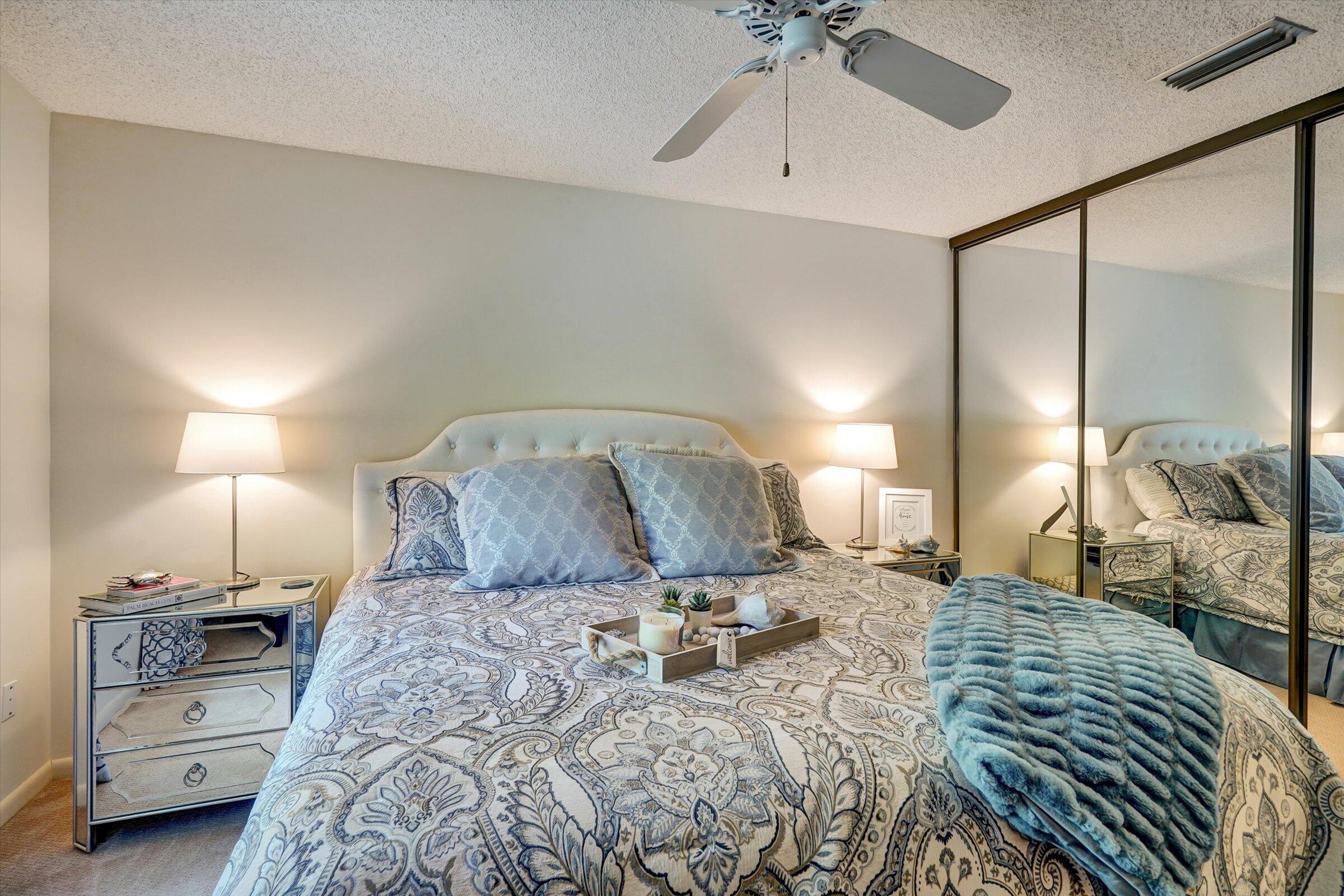 316 River Edge Road Jupiter, FL 33477 - Photo 40 of 53 a bedroom with a large bed and a chandelier