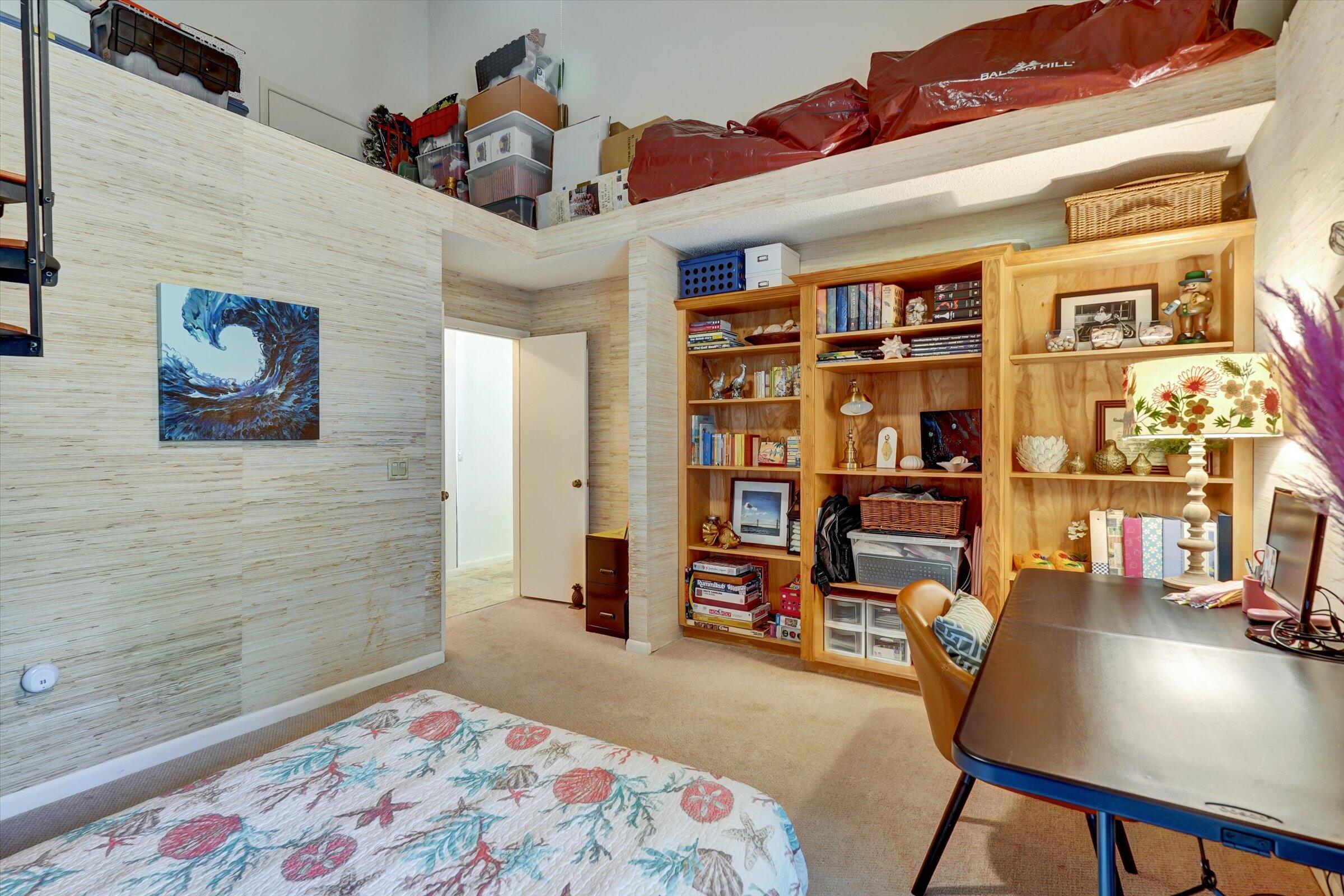 316 River Edge Road Jupiter, FL 33477 - Photo 43 of 53 a bedroom with a bed and a book shelf