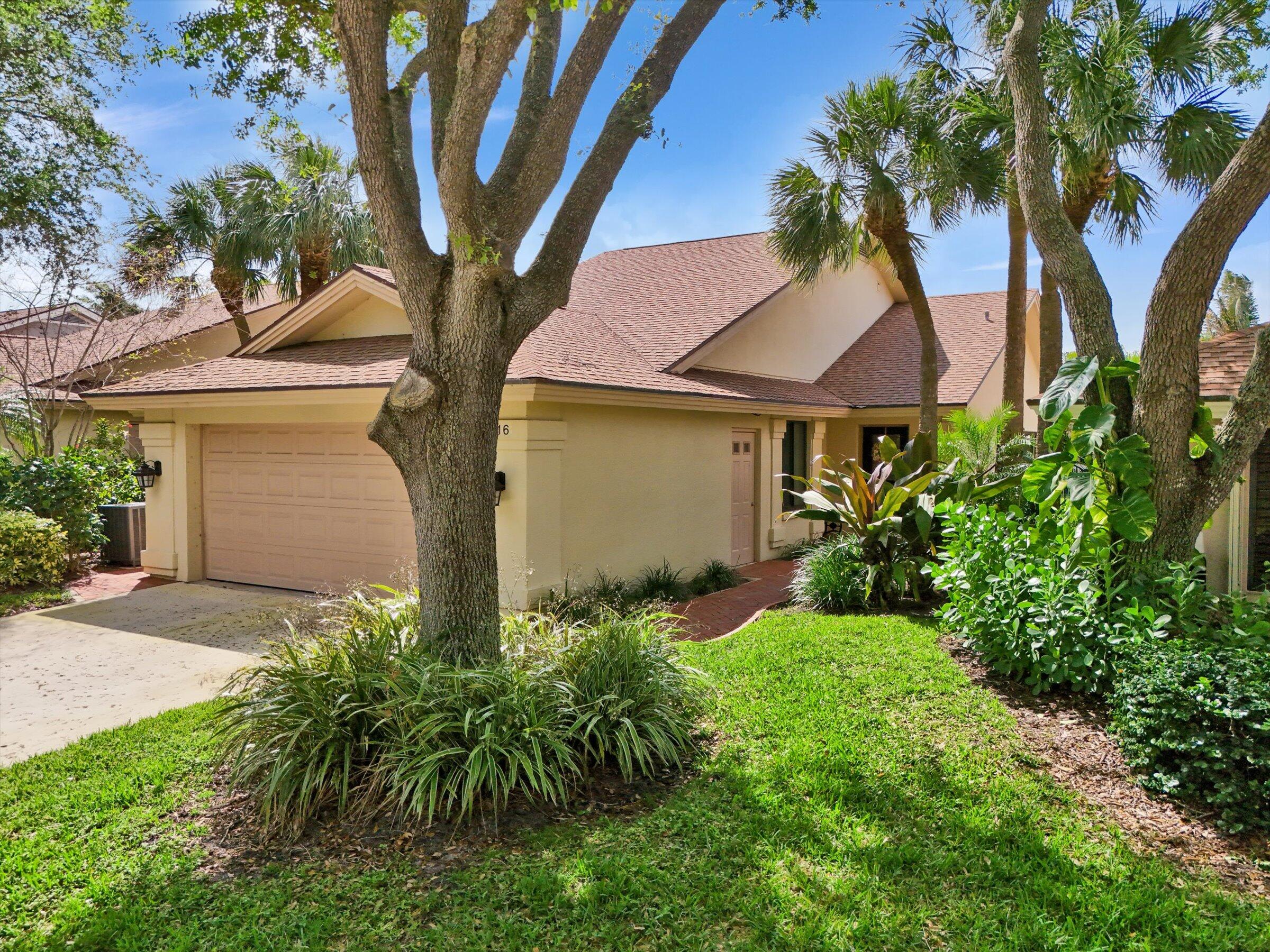 316 River Edge Road Jupiter, FL 33477 - Photo 45 of 53 a front view of a house with garden