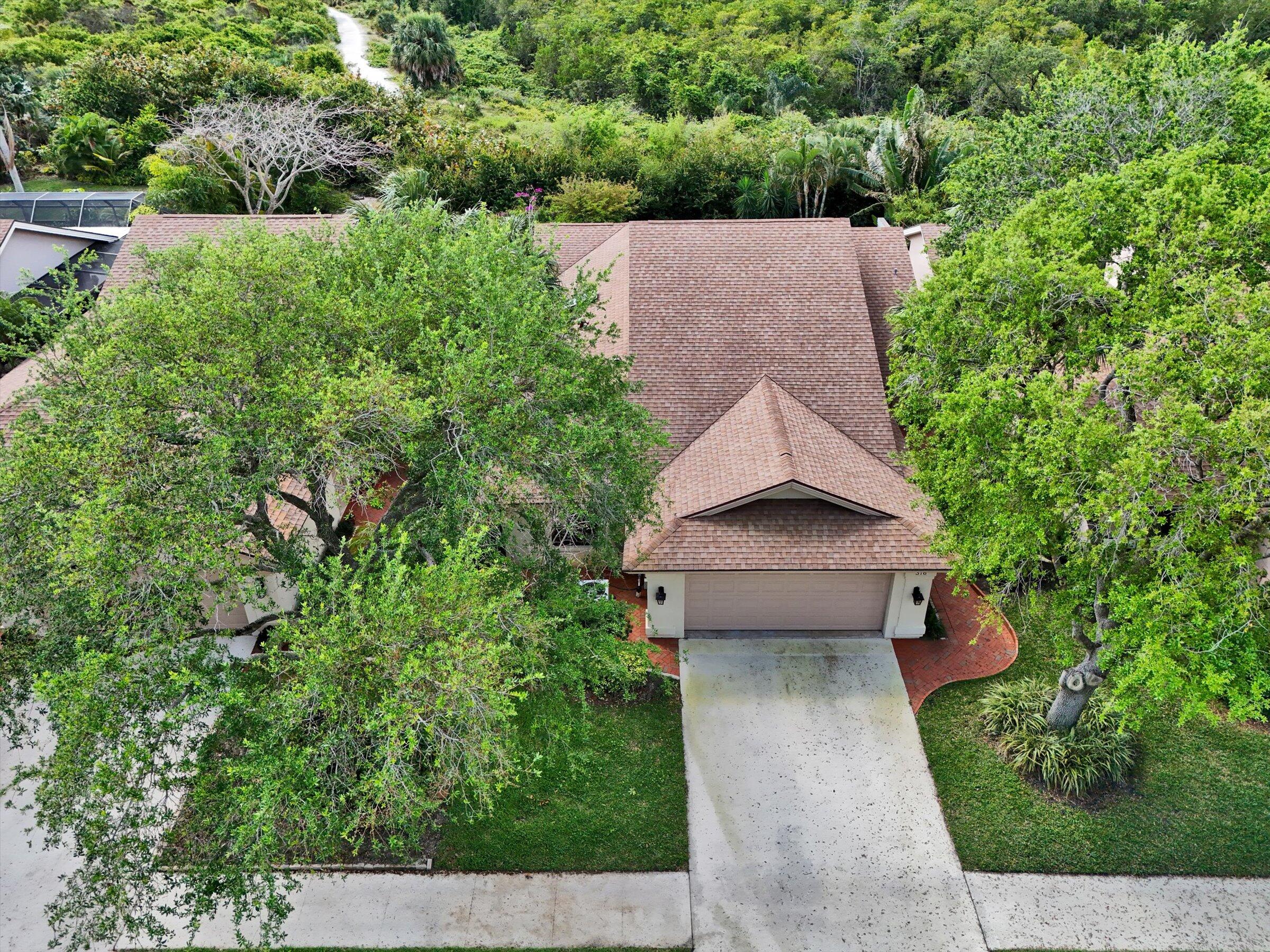 316 River Edge Road Jupiter, FL 33477 - Photo 46 of 53 an aerial view of a house with a yard plants and large tree
