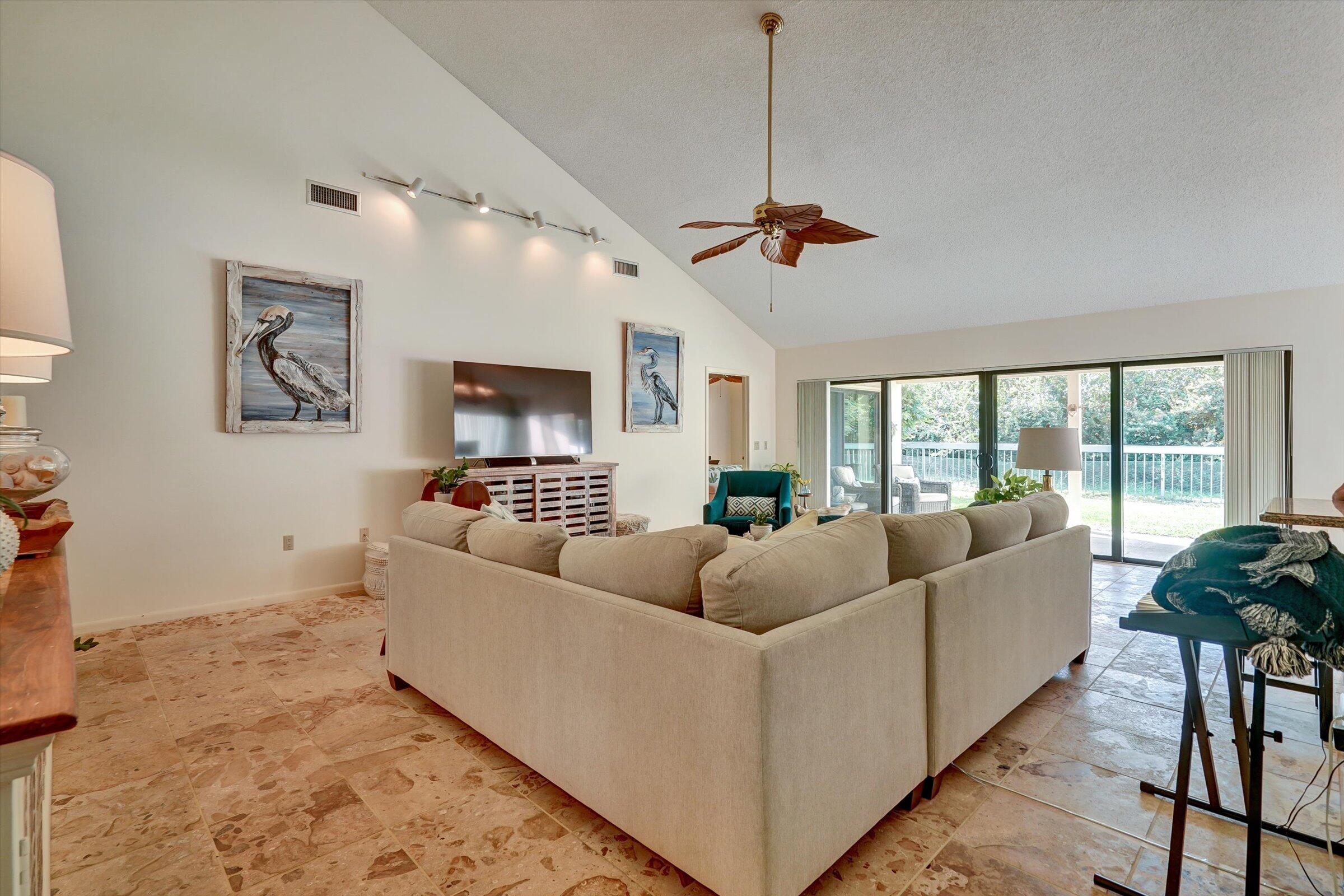 316 River Edge Road Jupiter, FL 33477 - Photo 4 of 53 a living room with furniture and a flat screen tv