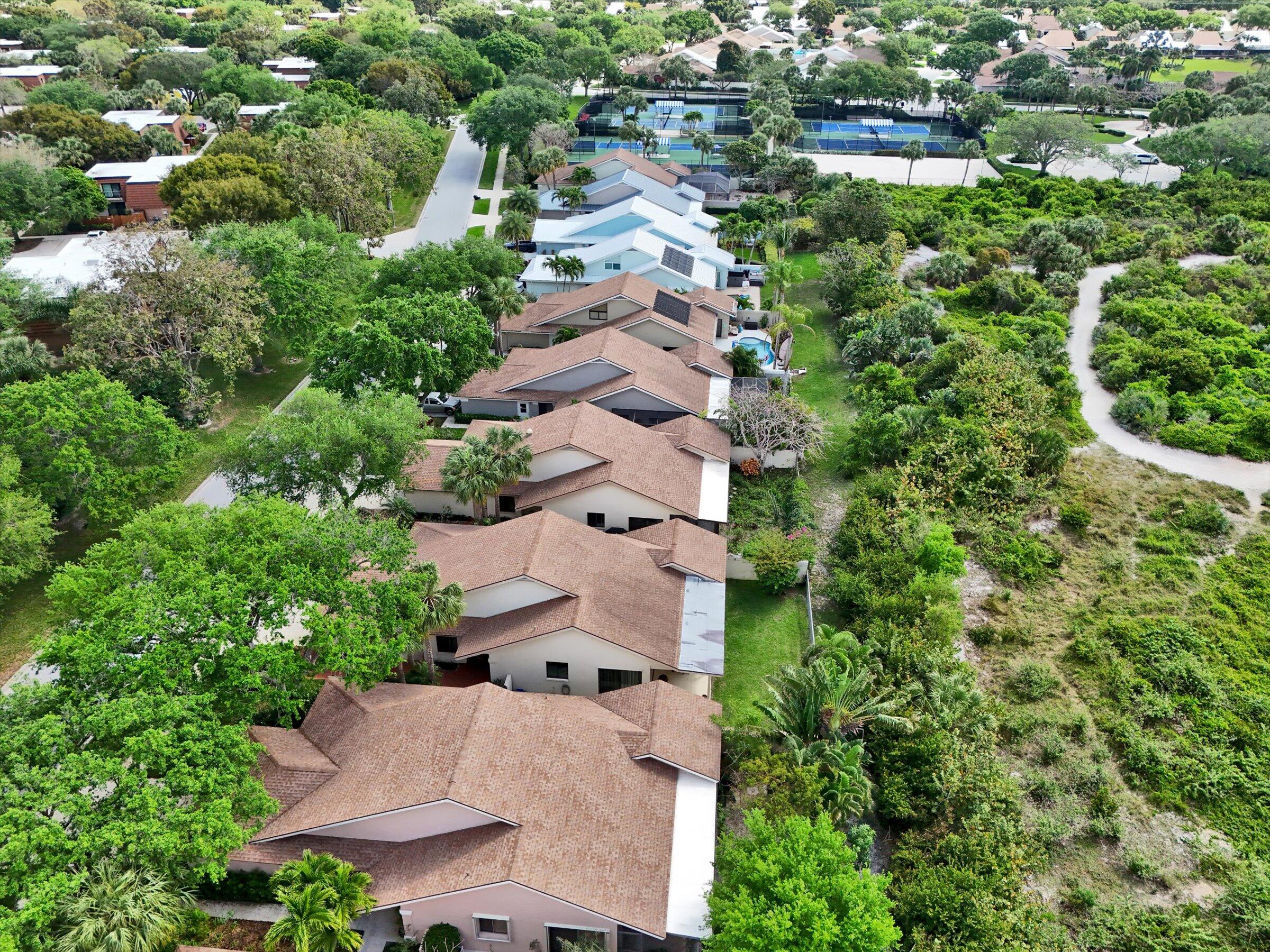 316 River Edge Road Jupiter, FL 33477 - Photo 48 of 53 an aerial view of residential houses with outdoor space and trees