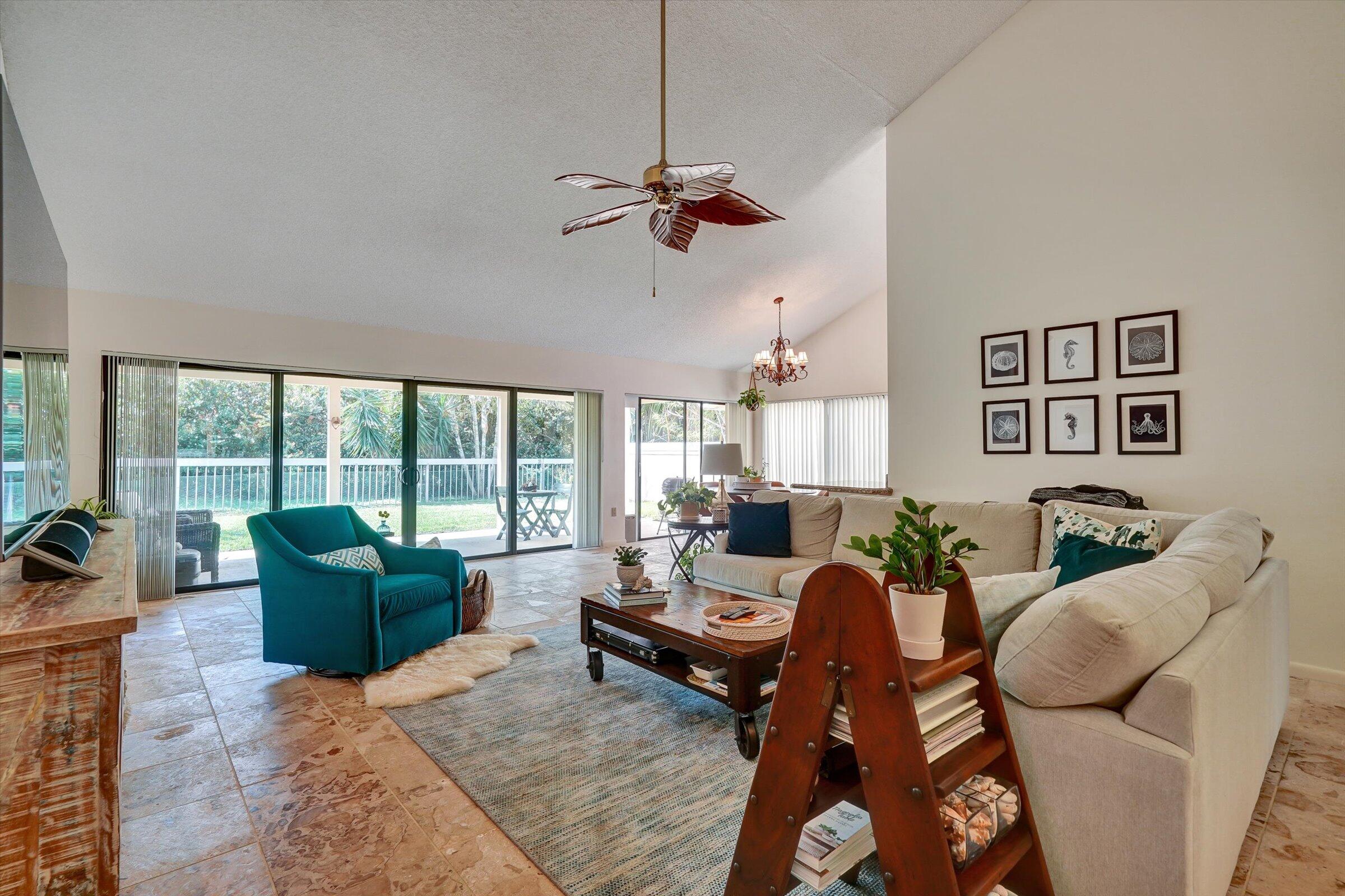 316 River Edge Road Jupiter, FL 33477 - Photo 5 of 53 a living room with furniture floor to ceiling window and a flat screen tv