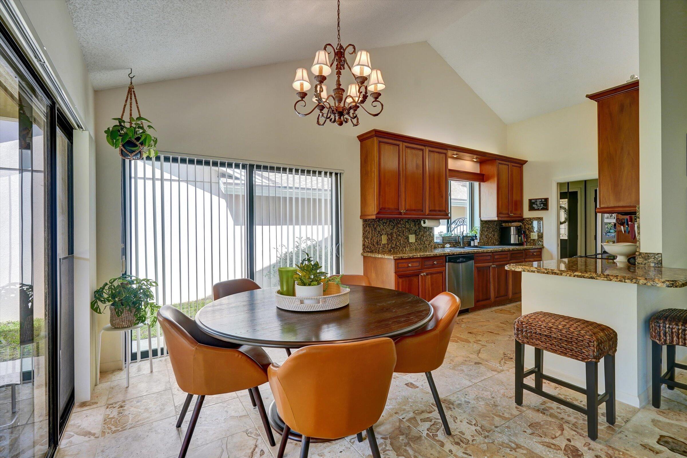 316 River Edge Road Jupiter, FL 33477 - Photo 6 of 53 a dining room with furniture a potted plant and a chandelier