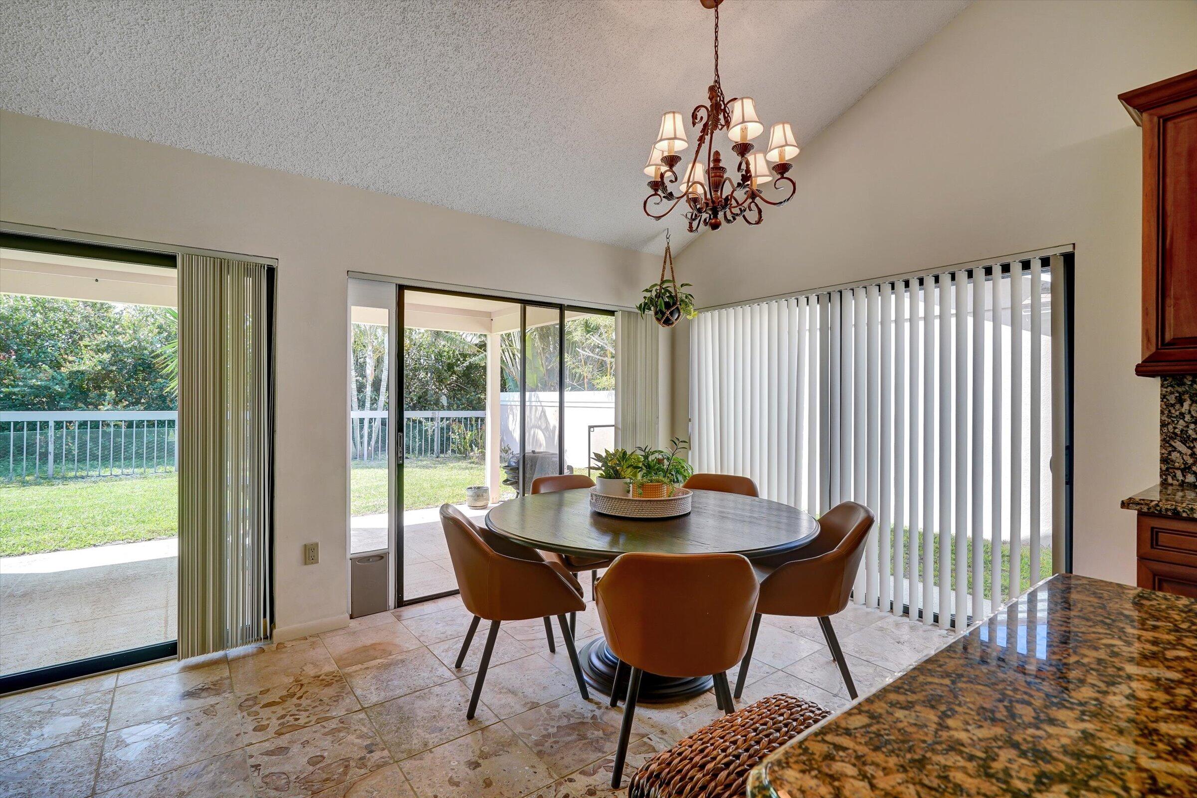 316 River Edge Road Jupiter, FL 33477 - Photo 8 of 53 a view of a dining room with furniture window and outside view