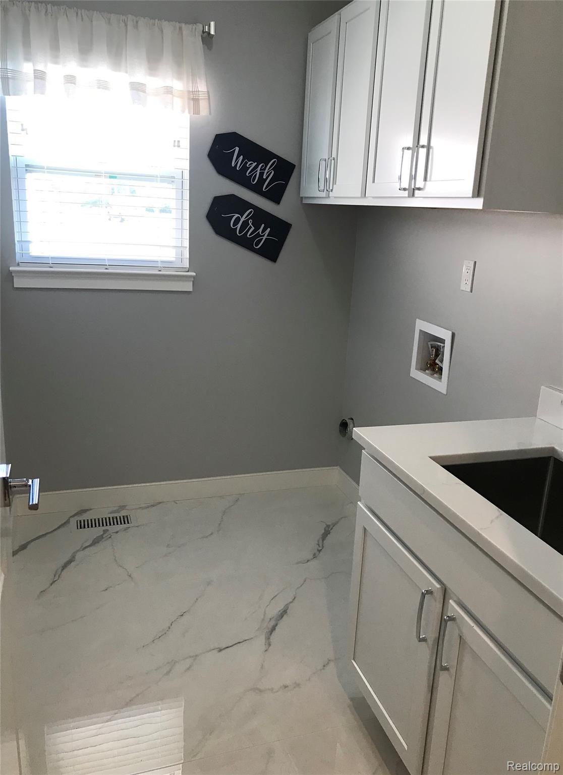 523 Ridge Point Drive Dundee, MI 48131 - Photo 15 of 34 Laundry room and cabinets.jpg