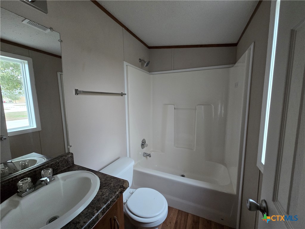 1911 Wald Road, Unit 9 New Braunfels, TX 78132 - Photo 14 of 14 a bathroom with a sink toilet and shower