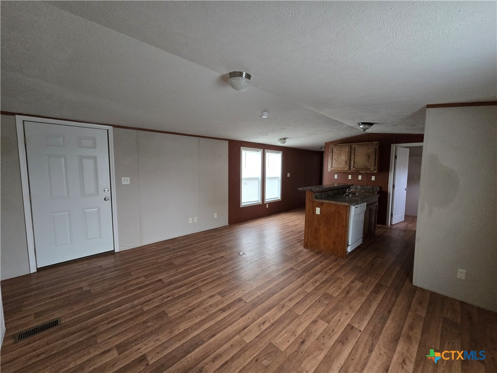 1911 Wald Road, Unit 9 New Braunfels, TX 78132 - Photo 3 of 14 a view of a kitchen with a sink and a refrigerator