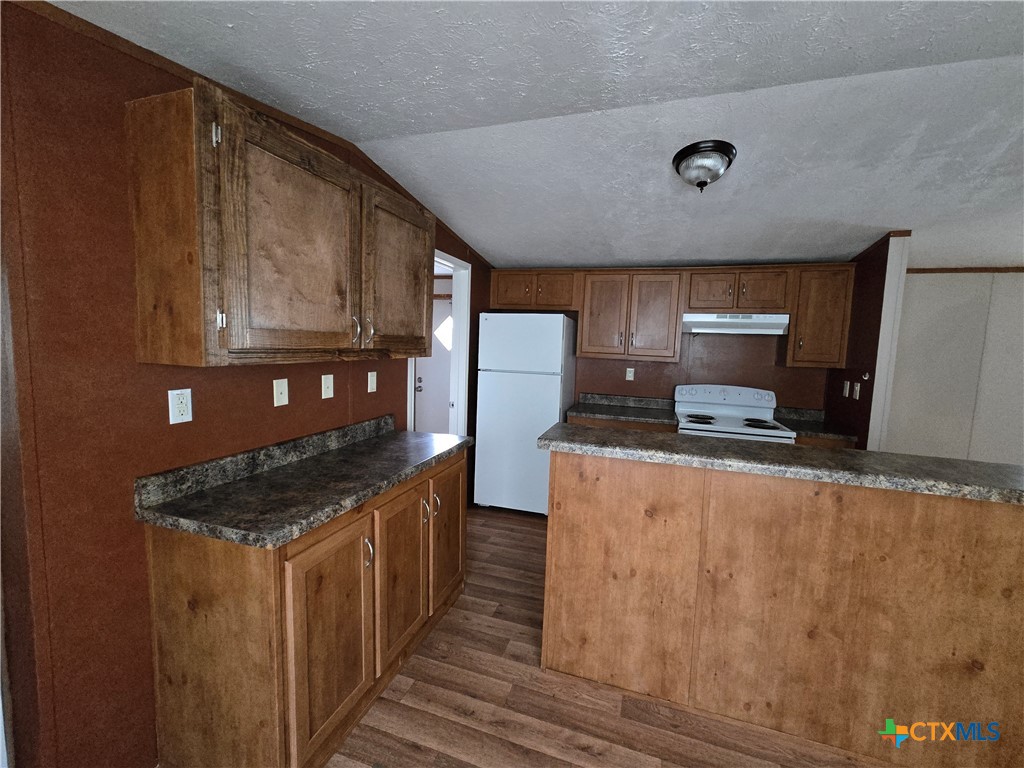 1911 Wald Road, Unit 9 New Braunfels, TX 78132 - Photo 5 of 14 a kitchen with stainless steel appliances granite countertop a stove a sink and a refrigerator