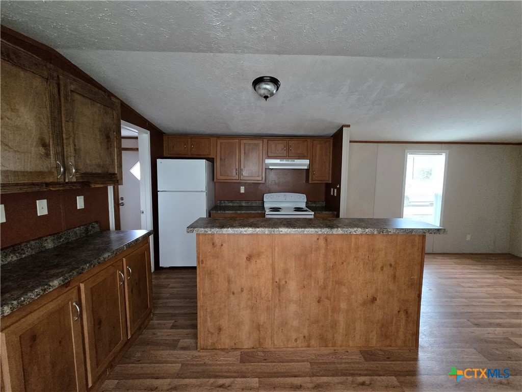 1911 Wald Road, Unit 9 New Braunfels, TX 78132 - Photo 6 of 14 a kitchen with stainless steel appliances granite countertop a stove a sink and a refrigerator