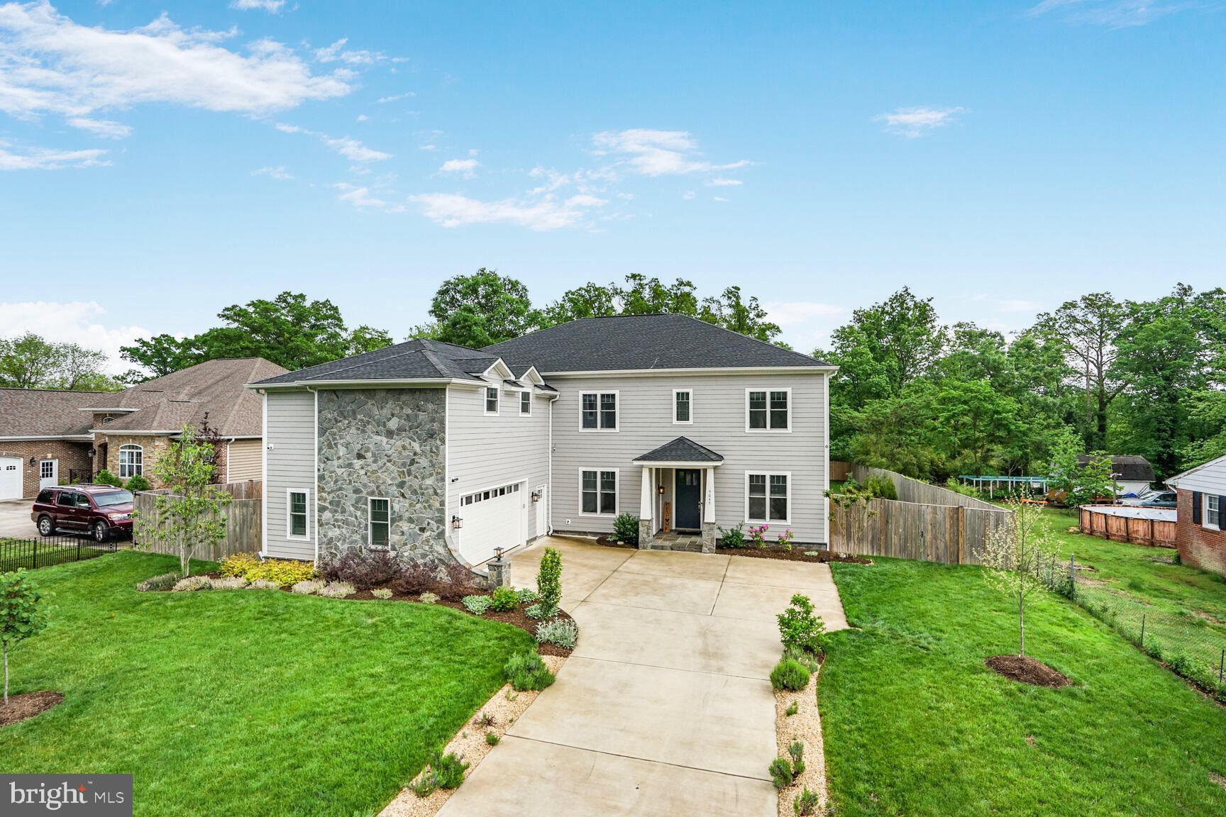a front view of house with yard and green space